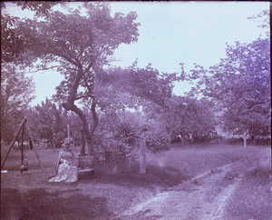 Woman sitting on a bench, East Douglas, Mass.