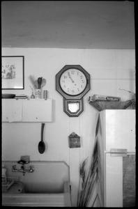 Kitchen sink, clock, and surroundings