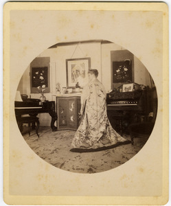 Abby F. Blanchard in the parlor, from behind, wearing a kimono