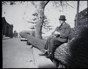 Wilfred H. Booth, seated on a fallen tree