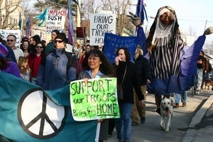 Anti-war marchers with peace banner, dog, and grotesque puppet: rally and march against the Iraq War