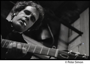 Tim Hardin playing guitar and smoking at the Unicorn Coffee House, Boston, Mass.