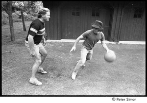 Paul Simon playing basketball with an unidentified man