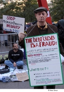 Occupy Wall Street: older man holding a protest sign and wearing a sandwich board