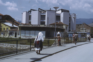 Woman crossing bridge