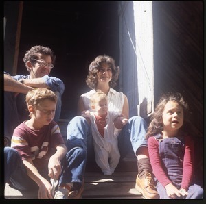 Keller family posed in the entrance to their barn, Wendell Farm