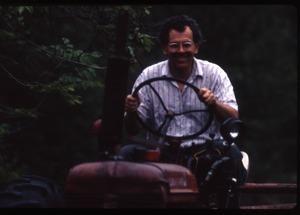 Dan Keller driving tractor, Wendell Farm