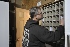 Rick Oliver sorting mail in the post office at the New Salem General Store