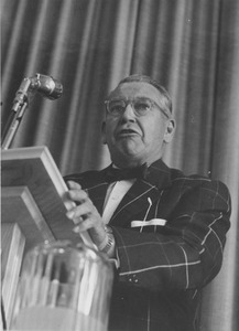 Edgar A. Perry speaking at podium