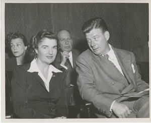 Arthur Godfrey seated on stage with client at Institute Day