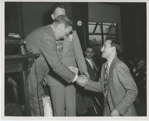 Arthur Godfrey shaking hands with client at Institute Day