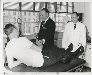 Bob Hope signing autograph for patient in doctor's office