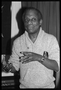 James Baldwin: informal portrait, gesturing, at the book party for Robert H. Abel