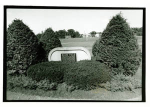Blake Field plaque surrounded by bushes (1993-1994)