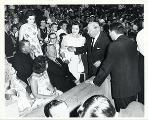 Mayor John F. Collins shaking hands with unidentified woman