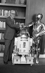 Unidentified man with R2-D2 and C-3P0 from Star Wars films at Boston City Hall