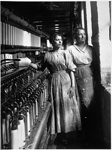 Two female textile workers at a spinning frame. [10]
