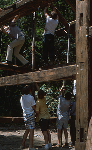 Readjusting rafters (1) at the Moon Barn Raising at entrance to Hopkins Forest on 2 August 1975.