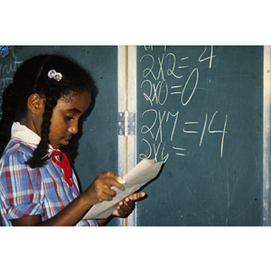 Child doing math at blackboard