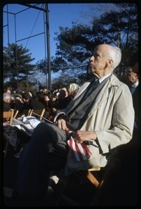 Norman Thomas, seated with an American flag, awaits his turn to address anti-Vietnam war protesters: Washington Vietnam March for Peace