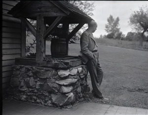 Sinclair Lewis leaning against a well