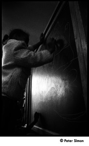 Child drawing on a blackboard, the Liberation School