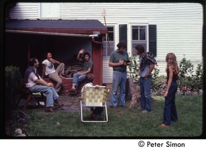 Commune members seated around outside the house, Tree Frog Farm Commune