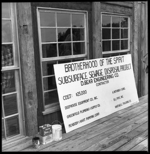 Sign at the Brotherhood of the Spirit communal dormitory marking the septic tank expansion project