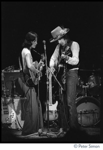 Joan Baez and Bob Dylan sharing a microphone, performing at the Harvard Square Theater, Cambridge, with the Rolling Thunder Revue