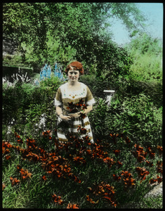 Mrs. Churchill's garden: daughter standing in garden with lilies