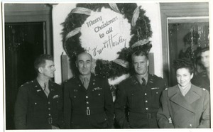 Christmas at the Office of Military Government, Berlin: Frank L. Howley, John J. Maginnis, Watson, and unidentified woman (left to right)