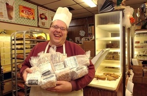 Vincent DiColo, president of Carol's Bakery, holds some of the loaves of low-carb rye and wheat bread that he makes