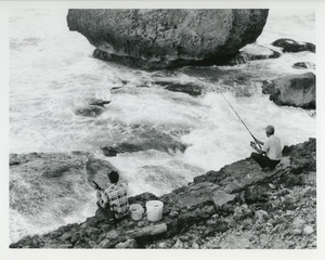 Fishermen on rocky shore