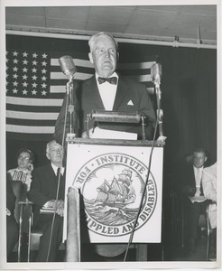 Bruce Barton speaking behind podium at Institute Day