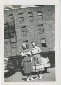 Unidentified women in parking lot outside unidentified building