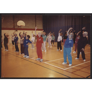 Adults stretching in gym at West Roxbury branch