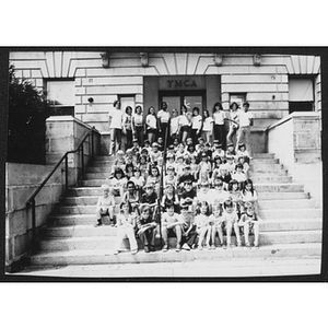 Staff and children pose for photo on exterior stairs of Hyde Park branch