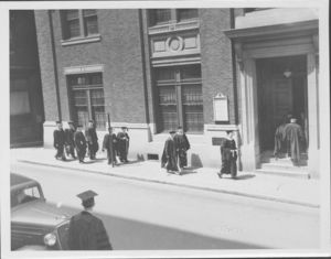 Graduates walking on Derne Street at the Suffolk University's first Baccalaureate exercises, 6/13/1937