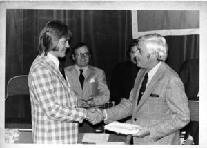Suffolk University Dean of Students D. Bradley Sulllivan presents an award to a student at the 1976 Recognition Day ceremony