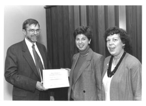 Lois Lopaten is presented with a certificate at the "Women at the Top" event at Suffolk University
