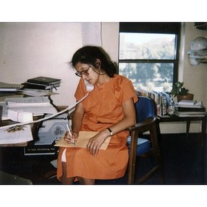 Inquilinos Boricuas en Acción's Executive Director Clara Garcia on the phone in her office.