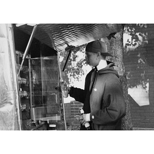 Young man at an outdoor vending stand or lunch truck.