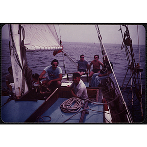 Five men looking at the camera on a sailing boat