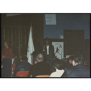 A woman speaking into a microphone while looking to her right at the MADD 1991 Poster and Essay Contest