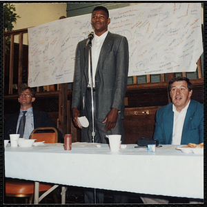 Former Boston Celtic Reggie Lewis stands at the microphone at a Kiwanis Awards Night