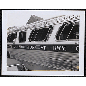 Boys peer out the open windows of a Plymouth and Brockton Street Railway bus