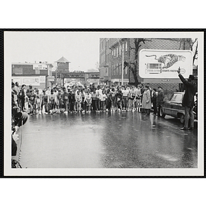 Runners gather behind the start line as they wait a man to fire the start pistol at the Roxbury Road Race