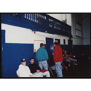 Men and teenage boys attend a basketball game