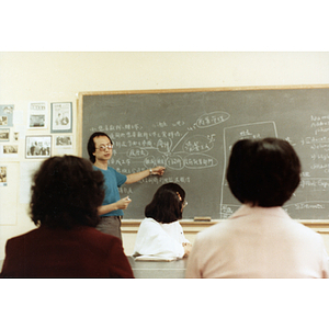 Students in a job placement class sit listening to their teacher at the front of the room