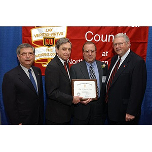 Inductee Joseph Golemme poses with his certificate and three others at the National Council Dinner